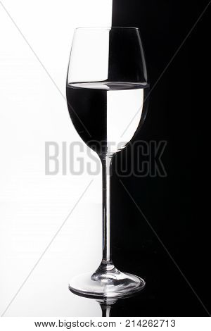 Glass with a red wine on a glass studio background