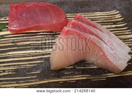 Fresh Japanese Hamachi white raw fish sashimi with tuna slice