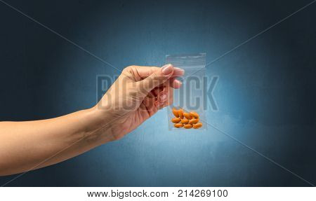 female hand giving drugs in plastic bag