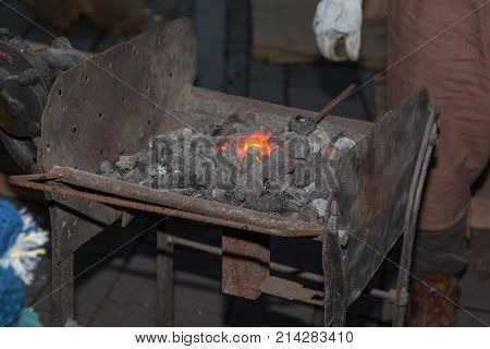 A Forging Furnace: Blacksmith Working Iron and Incandescent Charcoal.