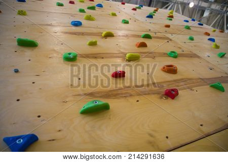 Full frame shot of the artificial climbing wall in the fitness club's brightest studs. Climbing wall for practicing