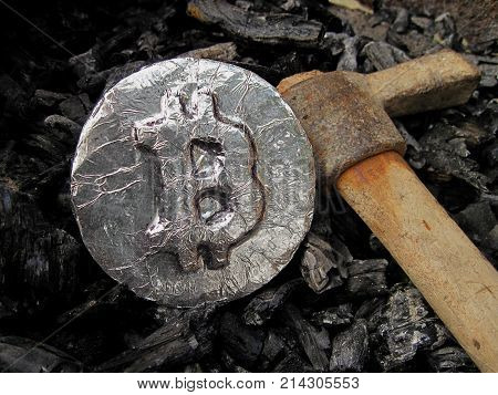 Bitcoin mining. A mine with real hardware. Symbols of block chain technology for crypto currency - metal coin, coal, pickaxe. Background for cryptocurrency and ICO transactions