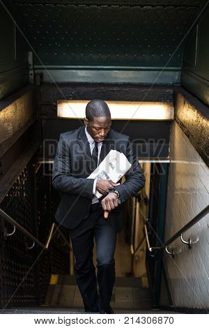 Businessman in full suit at Wall Street subway metro station