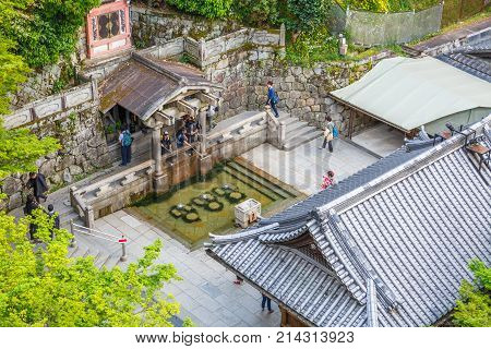 Kyoto, Japan - April 24, 2017: aerial view of Otowa Waterfall inside Kiyomizu-dera or Pure Water Temple. It was founded in 780 on the site of the Otowa Waterfall in Kyoto east hills.