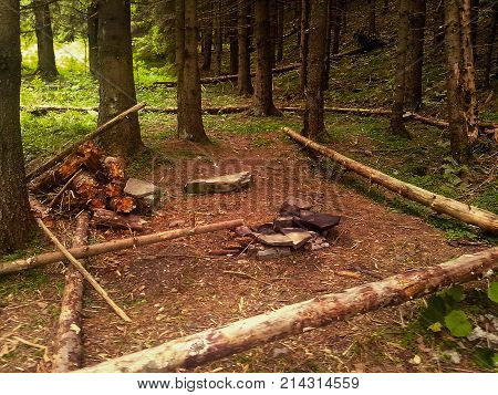 Empty camp stop with fireplace in deep forest