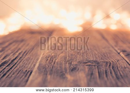 Glowing Bokeh Background With Empty Wooden Table. Christmas Background