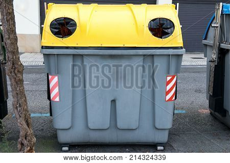 a spanich street recycling container for glass
