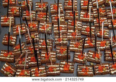 red caviar on black bread with butter. Healthy food. Fish appetizer. dark background. Snacks. buffet table. restaurant feed. New Year Christmas. Top view
