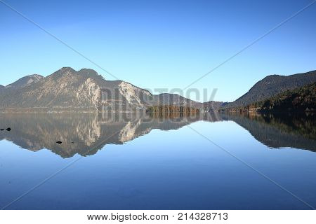 quiet blue lake with mountains in background