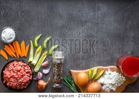 Composition of raw meat with vegetables and spice on wooden background. Top view. Copy space. Still life. Flat lay.