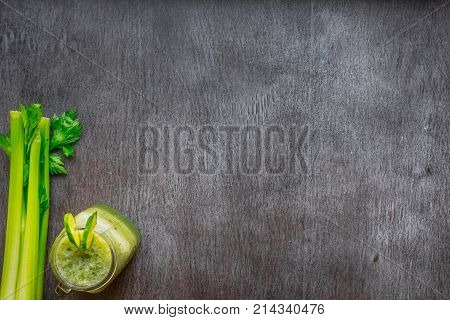 Green vegetable smoothie with celery and cucumber. Top view. Copy space. Still life. Flat lay.