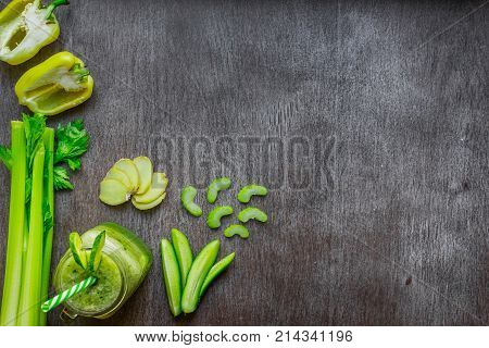 Green vegetable smoothie with celery, ginger and cucumber. Top view. Copy space. Still life. Flat lay.