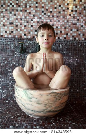 Child Sitting In Hammam