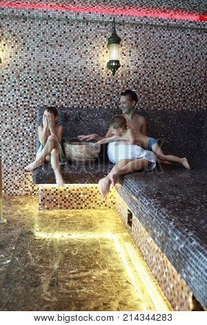 Woman with two children resting in hammam