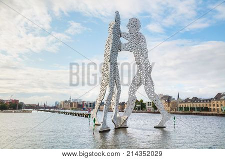 BERLIN - AUGUST 21 2017: Molecul Man sculpture on August 21 2017 in Berlin Germany. It's one in a series of aluminium sculptures designed by American artist Jonathan Borofsky installed at various locations in the world including Berlin.