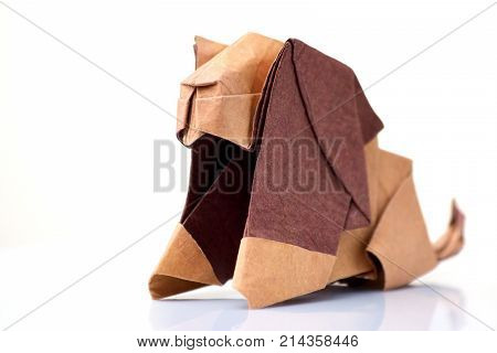 Lion origami miniature on white. Cute sculpture of animal, made of colored paper. Japanese art of folding paper.