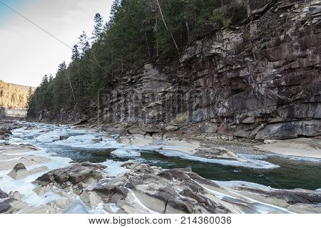 Winter mountain landscape with river and forest Prut river in Carpathians Ukraine Yaremche