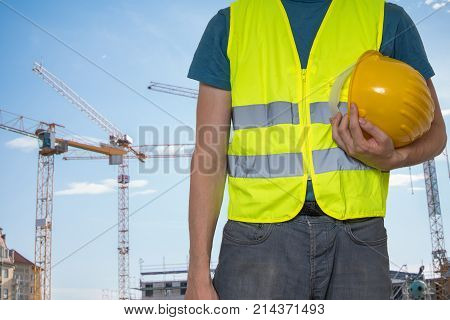 Worker with protective helmet on construction site..