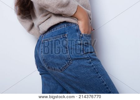 Sexy body of a beautiful girl. Attractive butt in blue jeans. Close up of sexy butt isolated on white background
