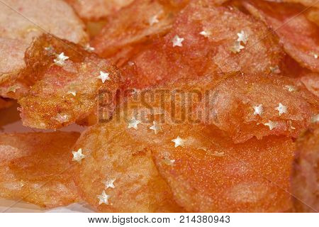 Fun but unhealthy party snack food. Fatty crisps with edible gold stars. Chemical and E number artificial additives including E171 used to make these potato chips look good.