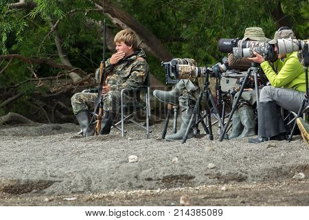 Kamchatka Peninsula, Russia - August 13, 2016: Group of professional photographers at a photo shoot on the Kurile Lake shore.