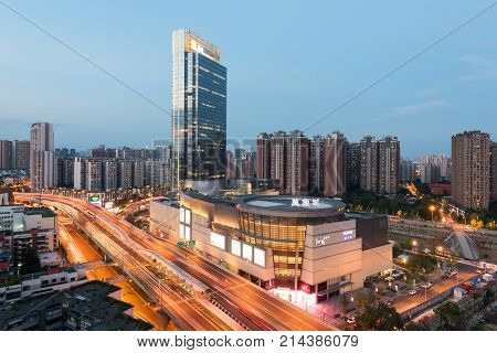 Chengdu, China - July 19, 2017 : WanXiangCheng mall aerial view at dusk with 2nd ring highway in the foreground in the eastern suburb of Chengdu city.