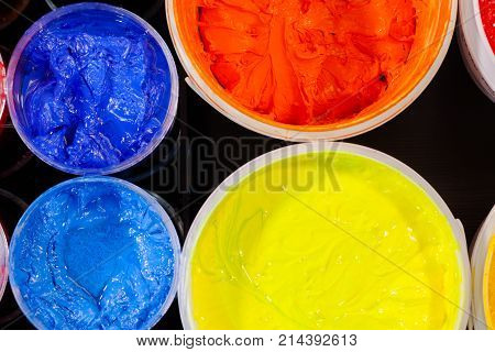 Top View Of Plastisol Ink In White Plastic Cans