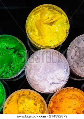 Top View Of Plastisol Ink In White Plastic Cans