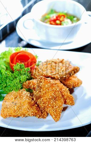 Fried Fish with herbs on white plate