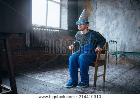 Man in tinfoil helmet and hypnotizing glasses, 