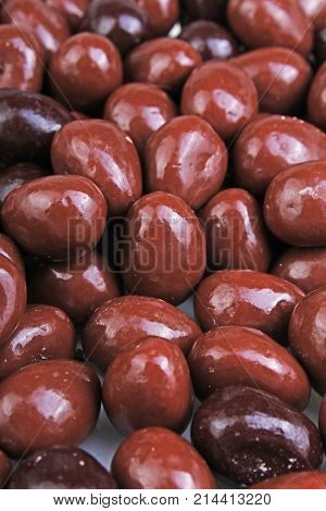 Dark and dairy chocolate balls. Chocolate drops as background texture pattern. Bon bons. Food.