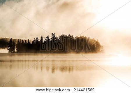 Lake of two rivers in algonquin national park ontario canada sunset sunrise with fog foggy mystical atmosphere background