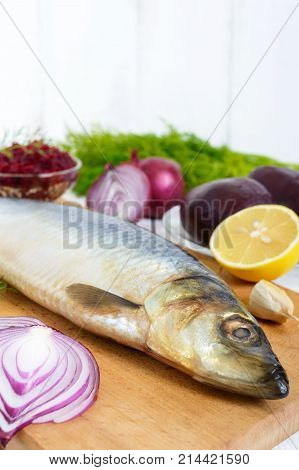 Whole salted herring with boiled beet red onion garlic lemon dill rye bread. Ingredients for sandwich salad.