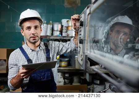 Modern worker browsing in the net while looking for information about new industrial equipment
