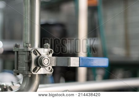 Stainless ball valve with blue handle. Industrial valves for special purposes.