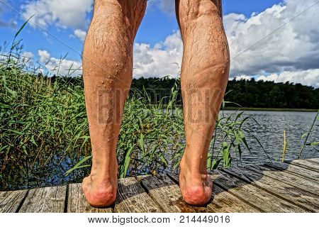 the wet legs of a man in a lake