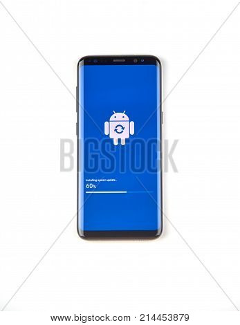 MONTREAL CANADA - NOVEMBER 12 2017: Samsung S8 device in process of software update with logo and progress bar on the screen. Samsung Galaxy S8 is one of the most popular cell phones.