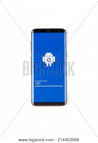 MONTREAL CANADA - NOVEMBER 12 2017: Samsung S8 device in process of software update with logo and progress bar on the screen. Samsung Galaxy S8 is one of the most popular cell phones.