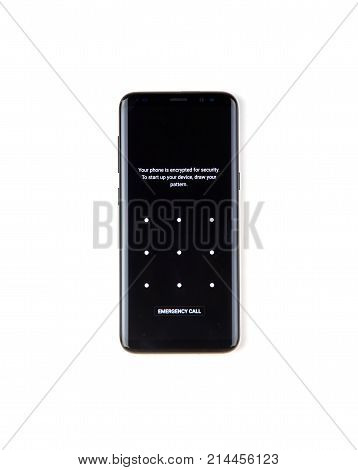 MONTREAL CANADA - NOVEMBER 12 2017: New encrypted black Samsung Galaxy s8 with draw pattern screen to decrypt the device over a white background.
