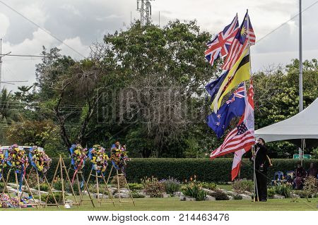 Labuan,Malaysia-Nov 12,2017:Man holding the Canada,Australia,Great Britain,India & New Zealand flags during the Remembrance Day at Labuan War Memorial park in Labuan,Malaysia.This event is held every year in November in remembrance of the unsung heroes.