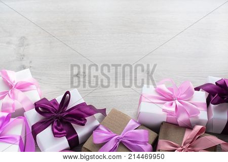 Gift boxes decorated with satin ribbon. The festive lights. Top view flat lay