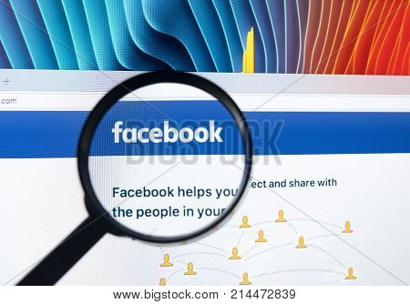 Sankt-Petersburg Russia November 20 2017: Facebook homepage one of the biggest social network website. Homepage of Facebook.com on Apple iMac monitor screen under magnifying glass.