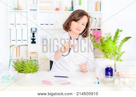 female physician medicine doctor with a stethoscope in the hand at workplace. Medical and health care. blood pressure, heartbit, disease healing, pharmacy and insurance concept.