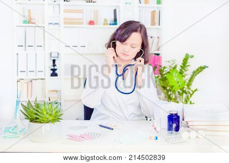 female physician medicine doctor with a stethoscope in the hand at workplace. Medical and health care. blood pressure, heartbit, disease healing, pharmacy, insurance and OSH concept.