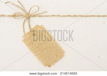Burlap Cloth Label Tag and Tied Rope Bow over Cardboard Paper Jute Price Gift Decoration
