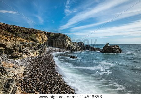 Long exposure on pebbles beach on the Cayola coast in Les Sables d'Olonne (Vendee, France)