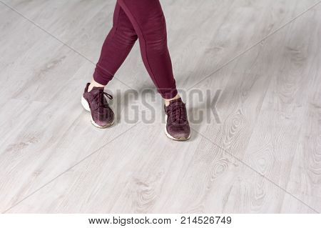 Female hip-hop dancer, cropped image. Casual dancer woman in sport clothing practicing dance element in studio.