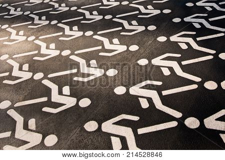Pedestrian crossing sign on asphalt in city public park. The walking man. Permission to walk pedestrians.
