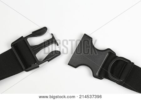 black plastic Fastex clip for backpacks on a white background