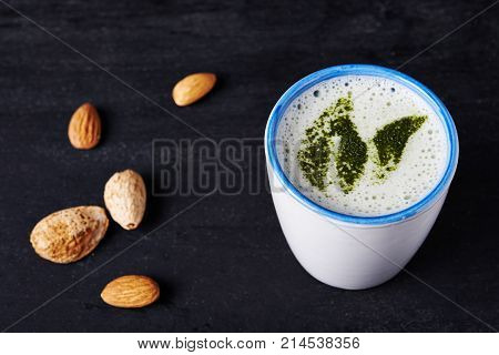matcha latte with almond milk in cup